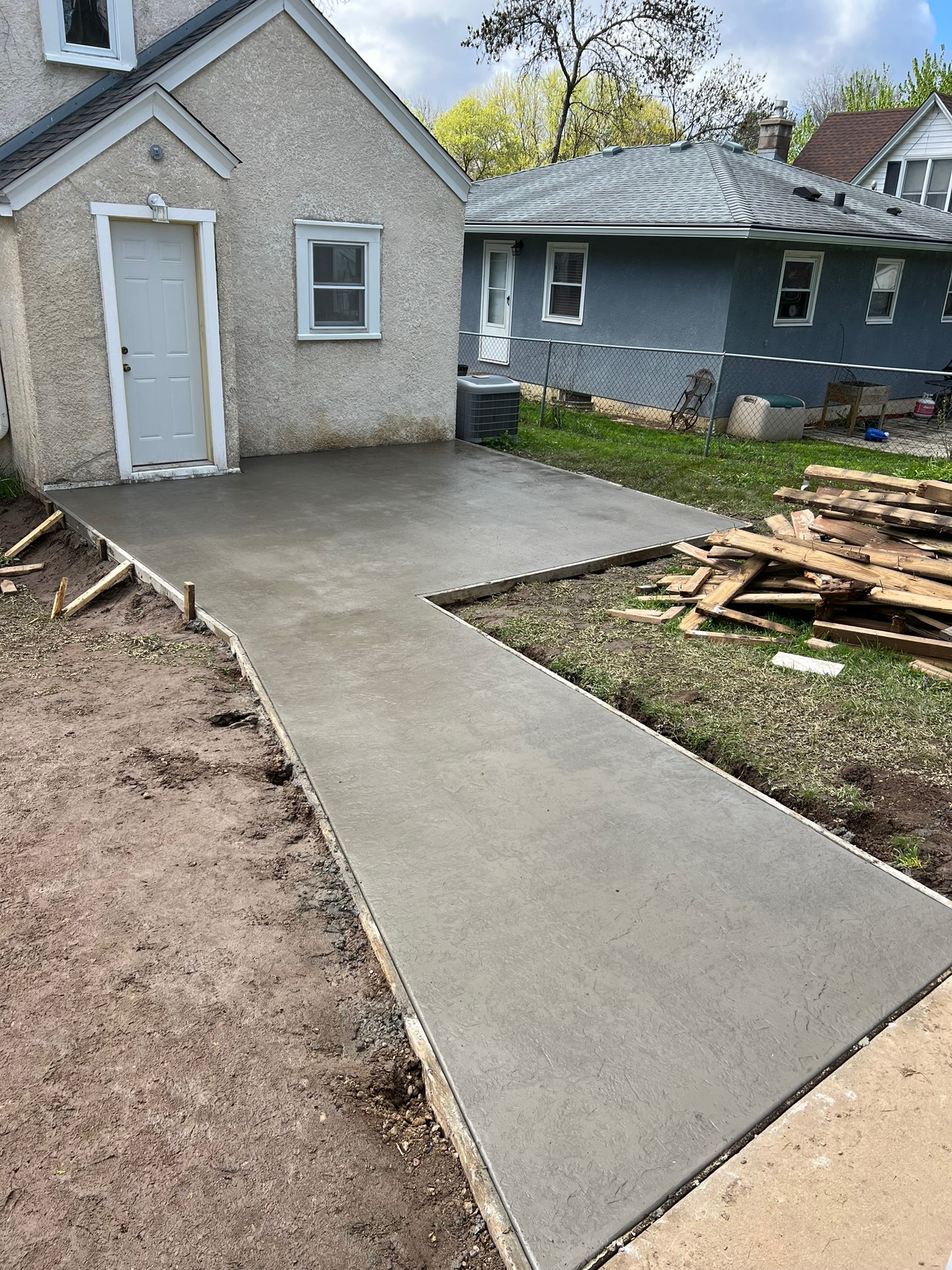 Outdoor concrete patio and walkway by Masterset Concrete